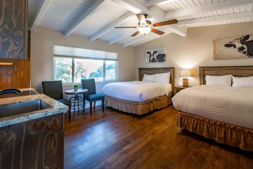 a hotel room with two beds and a sink at Apple Tree Inn in Julian