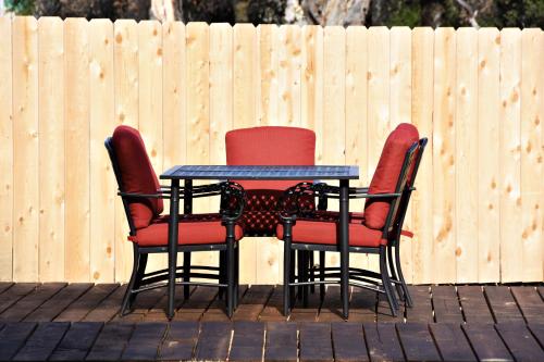 two chairs and a table in front of a fence at Apple Tree Inn in Julian