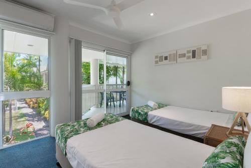 Ένα ή περισσότερα κρεβάτια σε δωμάτιο στο Tropical Nites Holiday Townhouses