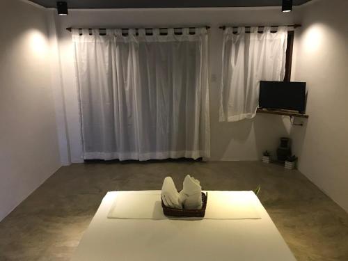 a room with a table with a basket in front of a window at PAYAG SUITES in General Luna