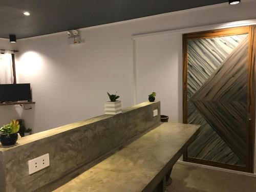 a lobby with a wooden sliding door and a bench at PAYAG SUITES in General Luna