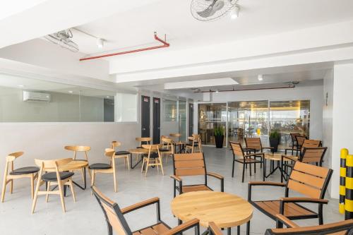 a room with tables and chairs in a restaurant at iHotel Uptown BGC in Manila