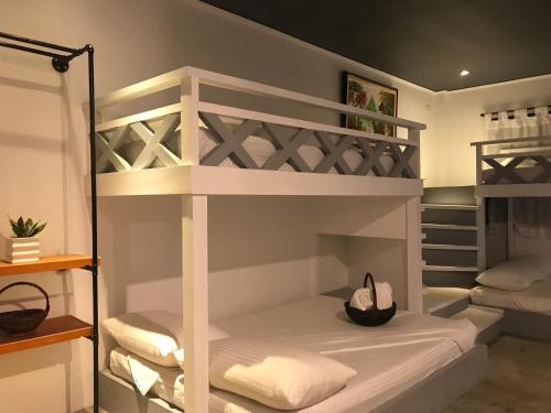 a room with two bunk beds with a hat at PAYAG SUITES in General Luna