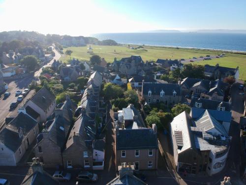 an aerial view of a town with houses and the ocean at Rose Cottage, Fishertown in Nairn