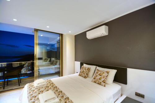 a bedroom with a bed and a large window at Villa Ahiska in Kalkan