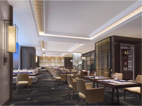 a restaurant with tables and chairs in a room at Novotel Changsha International Exhibition Center in Changsha