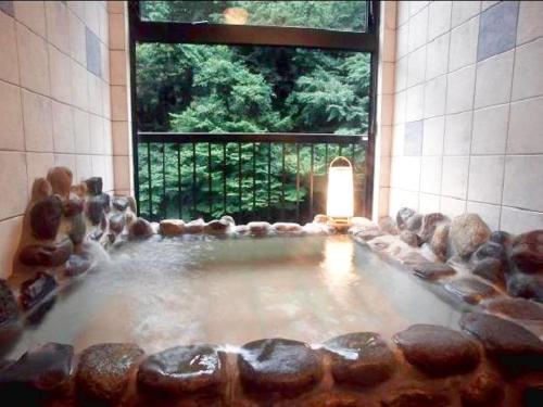a large pool of water in a room with a window at Ichigekan / Vacation STAY 8475 in Nakanojo