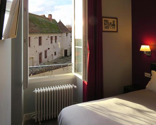 Postel nebo postele na pokoji v ubytování Hôtel Le Dormeux