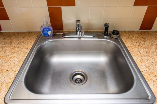 a stainless steel sink with a bottle of water in it at Hi-Tide Resort in Moclips