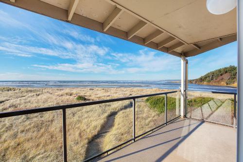 a view of the beach from the balcony of a house at Hi-Tide Resort in Moclips