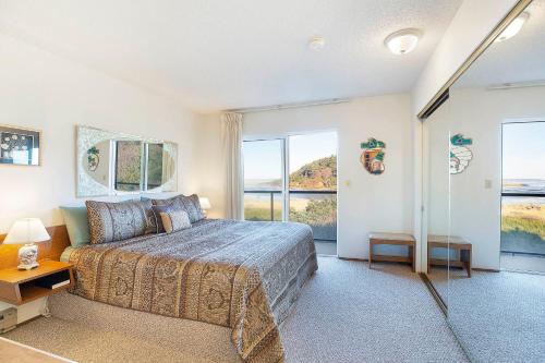 a bedroom with a bed and a large window at Hi-Tide Resort in Moclips
