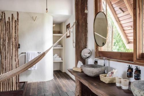 a bathroom with a sink and a mirror at Casa Blanca in Holbox Island