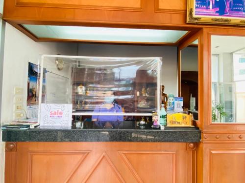 a counter in a kitchen with a glass window at City Residence in Bangkok