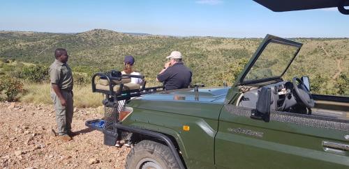 a group of people sitting in the back of a truck at Schrikkloof Private Nature Reserve, home of The Lions Foundation in Bela-Bela