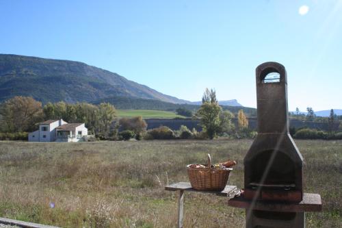 a bottle of wine sitting on a table next to a field at Verdon Vacances in Saint-André-les-Alpes