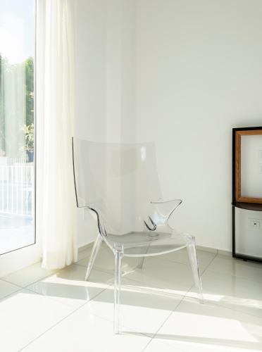 a white chair sitting in front of a window at Apollon Club & Thermal Spa in Ischia