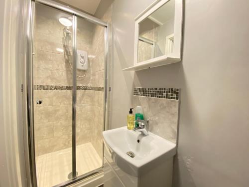 a bathroom with a sink and a shower at Ruskin Place by SG Property Group in Crewe