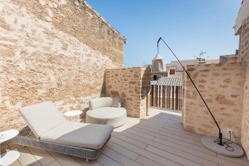 a patio with a chair and a lamp on a building at Forum Boutique Hotel & Spa - Adults Only in Alcudia
