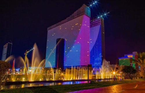a large building with lights on it at night at Orbi city in Batumi