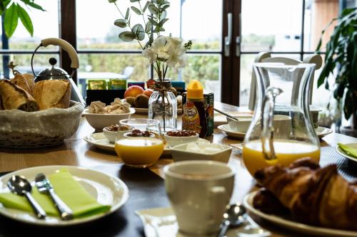 a table with breakfast food and orange juice on it at Dartmoor Cottage in Merris