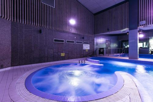 a large swimming pool in a large building at Spa Hotel Härmä - Härmän Kylpylä in Ylihärmä