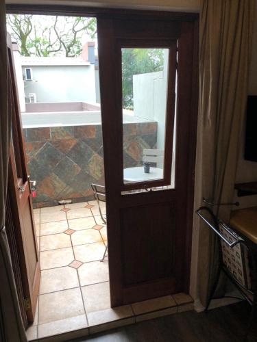 a door leading to a patio with a window at 314 on Clark Guest House in Pretoria