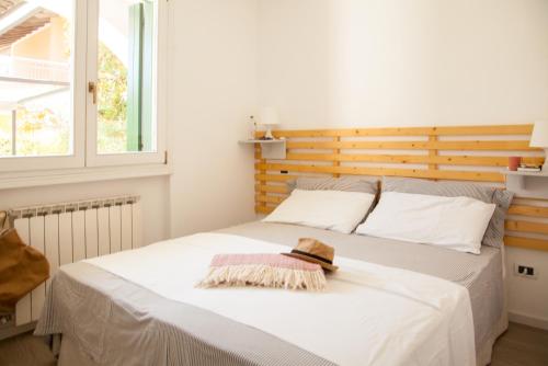 a bedroom with a bed with a hat on it at La Casa di Giò in Caorle