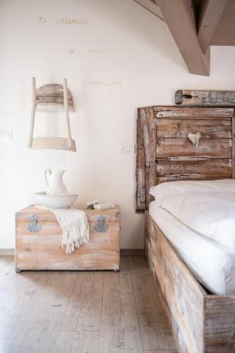 a bedroom with a bed and a table and a chair at Berry House in Vigolo Vattaro