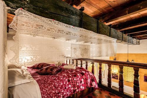 a bedroom with a bed with a white curtain at La Scala in Rome