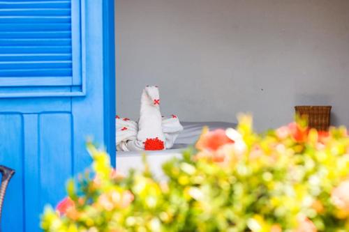 a stuffed cat is sitting on a window sill at Pousada Les Alizes in Icaraí