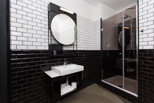 a bathroom with a mirror and a sink at Hotel Rum Budapest in Budapest