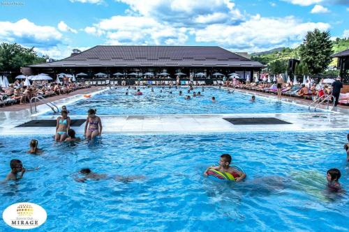 a group of people in the swimming pool at a resort at Mirage Resort & Spa in Vişeu de Sus