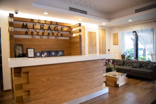 a living room with a couch and a wall of wood at Mirage Resort & Spa in Vişeu de Sus