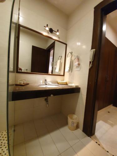 a bathroom with a sink and a mirror at S Chalet Islamabad in Islamabad
