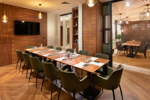 a conference room with a long table and chairs at Time Boutique Hotel in Split