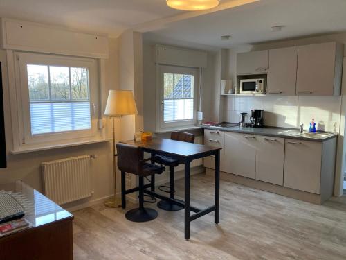 a kitchen with a desk and a table in it at Hotel Wintersmühle in Bielefeld