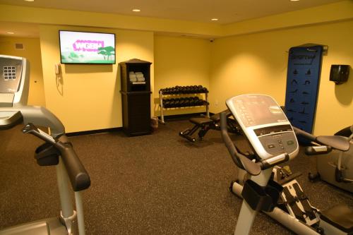 a gym with two exercise bikes and a tv at Publick House Historic Inn and Country Motor Lodge in Sturbridge