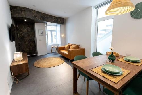 a living room with a table and a couch at Casa 55 in Aveiro