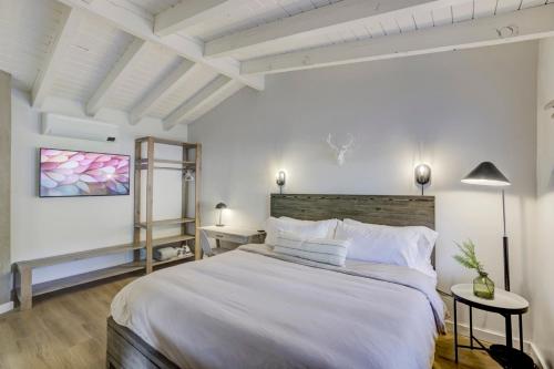 a white bedroom with a large bed with white pillows at South Lake Chalet-Boutique Suite-Minutes to Heavenly & Lake Tahoe in South Lake Tahoe