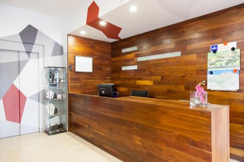 a lobby with wood paneling and a reception desk at Hotel Miera in Liérganes