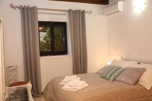 a bedroom with a bed with towels on it at Xigia Escape villas in Khartáta