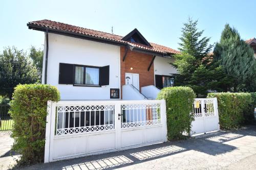 a white fence in front of a house at Villa Mina Kladovo, 5-Bedroom Villa with Pool for up to 12 People in Kladovo