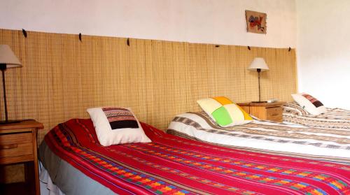 Una cama o camas en una habitación de Huaira Huasi