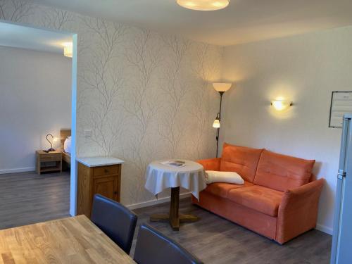 a living room with a couch and a table at Hotel Wintersmühle in Bielefeld