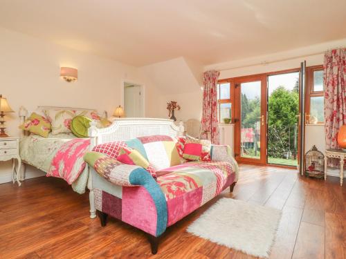 a bedroom with a bed and a couch at Pendle View in Blackburn