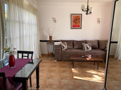 a living room with a couch and a table at Delta Sharm Apartment in Sharm El Sheikh