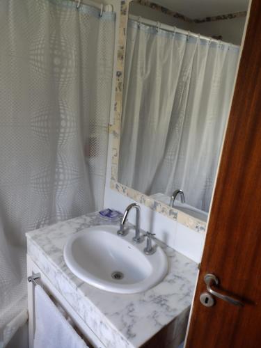 a bathroom with a sink and a mirror at Abril Village in Tandil