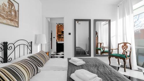 Posteľ alebo postele v izbe v ubytovaní Comfy Apartments - Stare Miasto z Ogrodem