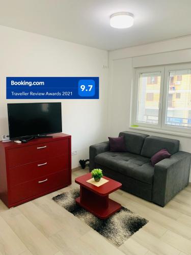 a living room with a couch and a coffee table at Apartman Saga Premium Garaza Parking Vauceri Ne in Soko Banja