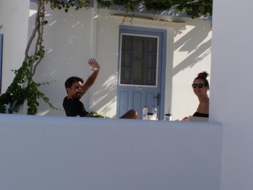 a man and a woman standing in front of a house at Elena Studios & Apartments in Piso Livadi
